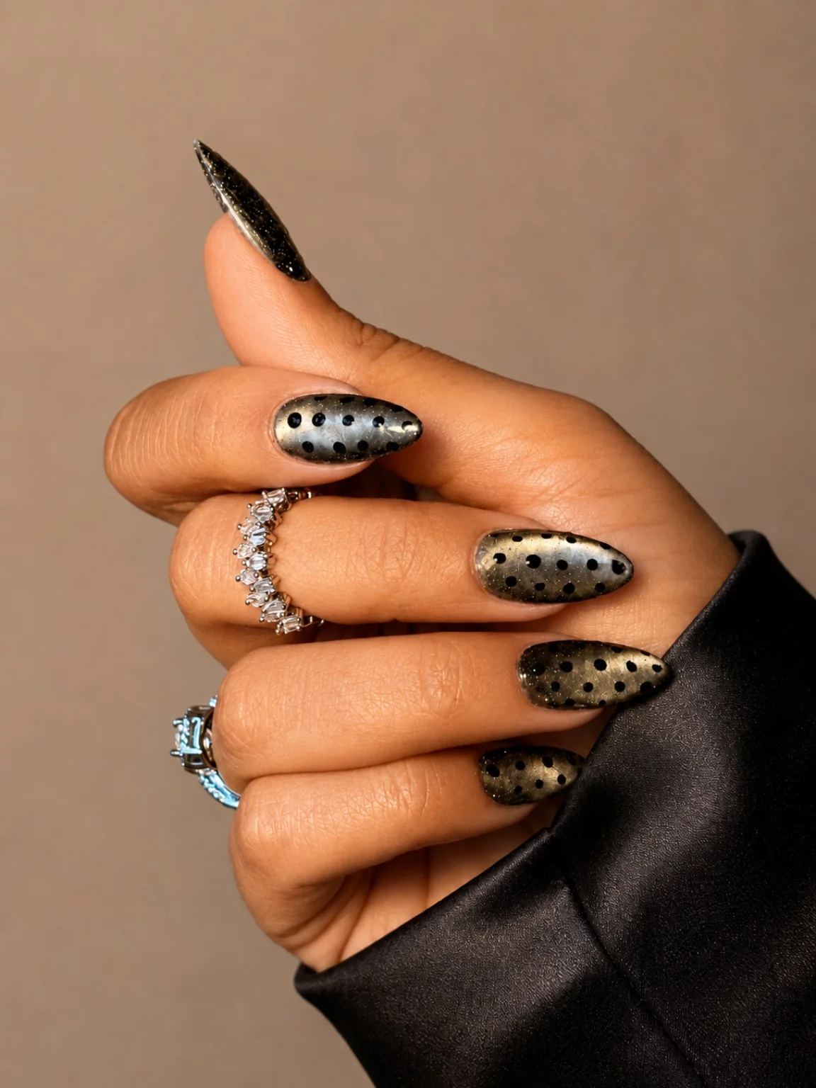 Smoked polka almond nails on black satin by Marzieh Nail Atelier